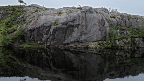 Rocky mountain pond surrounded by forest and granite formations in rural Norway. Stock Footage 328131929