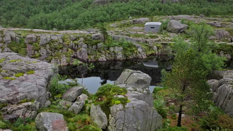 Rocky mountain pond surrounded by forest and granite formations in rural Norway. Stock Footage 328132017