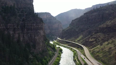 Rocky Mountain Range with River Next to Highway Scenic Landscape 스톡 동영상 160716864