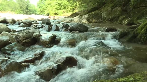 A rocky mountain river. A large stream of water descends over the rocks Video stock 171907568