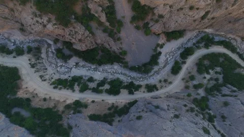 A rocky mountain road with a river running through it Stock Footage 327854580