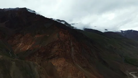 Rocky Mountain Slope Covered With Clouds drone view Stock Footage 308917616