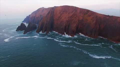 Rocky mountain surrounded by sea Stock Footage 63628875