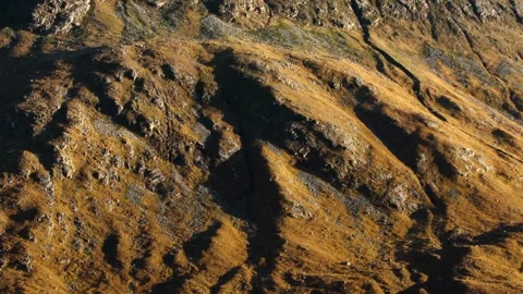 Rocky mountain terrain casting shadows in the evening, autumn Stock Footage 144692419