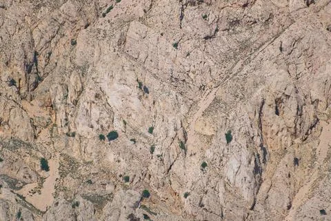 Rocky mountain terrain with sparse vegetation and rugged landscape Stock Photos