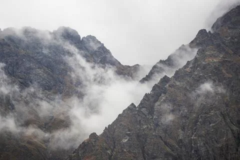 Rocky Mountain top with most clouds and fog on a rainy day Stock Photos