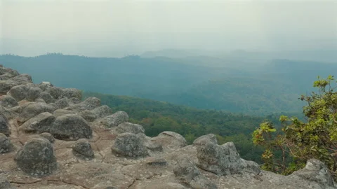 Rocky mountain viewpoint with misty forest landscape, serene and Stock Footage 282301290