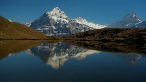 Rocky mountains and reflection on the surface of the  Bachalpsee lake. Video stock 201164976