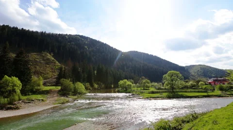 Rocky mountains and river with a rapids flowing in a valley between mountain Stock Footage 63780713