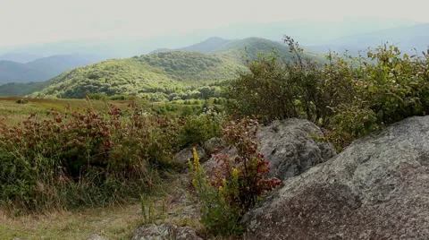 A rocky mountainside with a view of the mountain range. Vídeos de archivo 54980892