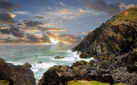 Rocky Ocean Cliffs at Sunset with Dramatic Coastal Seascape Stock Photos