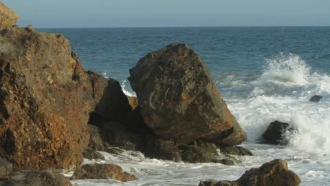 Rocky ocean front. Waves crashing into rocks on beach. slomo A Video stock 102402973