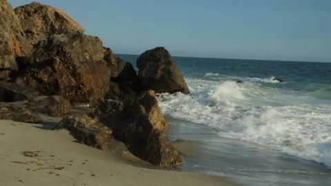 Rocky ocean front. Waves crashing into rocks on beach. slomo wide Stock Footage 102403011