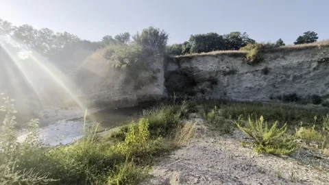 Rocky or clay wall and natural gullies overlooking a river bed Stock Footage 344136479