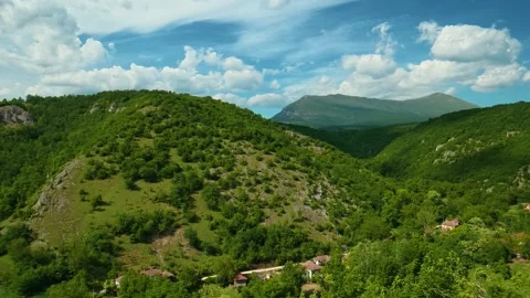 Rocky outcrop frames foreground with wild green plants. Vrmdza Fortress. Serbia Stock Footage 338021672