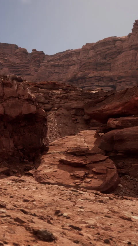 Rocky path through desert terrain in a remote canyon during midday sun Video stock 337992687