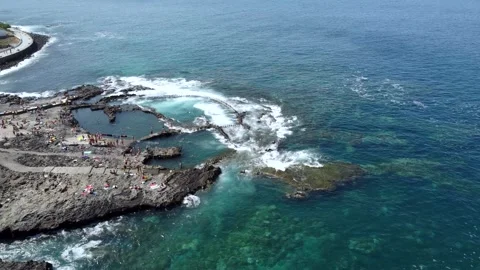 Rocky pool with unrecognizable people sunbathing in Agaete, Gran Canaria Stock Footage 279217036