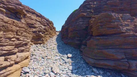 Rocky ravine trail leading down to coastal water, natural landscape scenery Stock Footage 340451111