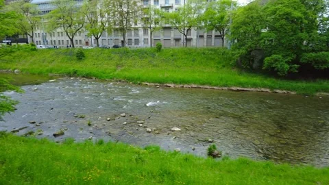Rocky river flows through green urban park in Zurich city Switzerland Stock Footage 334629594