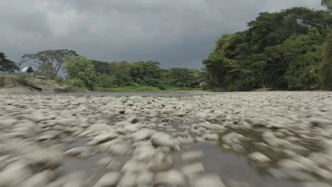 Rocky river low angle drone shot Video stock 247399914