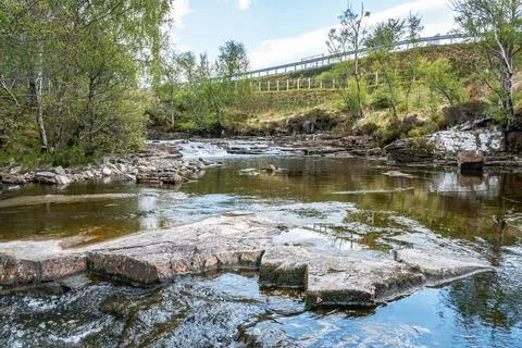 Rocky river with road background Stock Photos