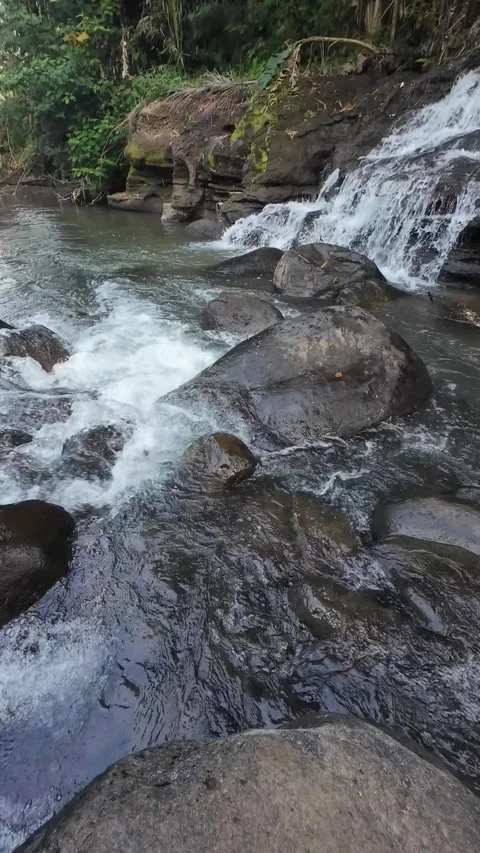 Rocky River Stream Flowing Through Wet Stones in Vertical 4K Stock Footage 336748804