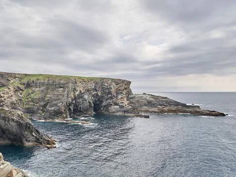 Rocky sea cliffs under dramatic cloudy sky 스톡 사진