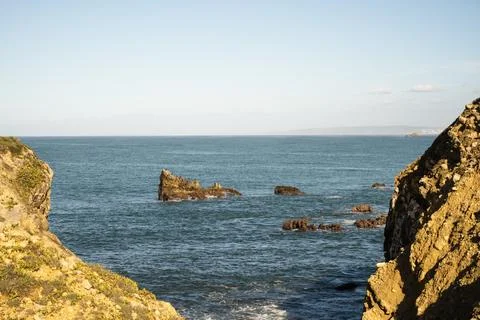 Rocky sea stack between coastal cliffs near Peniche Portugal Stockfoto's