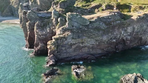 Rocky Sea Stacks and Cliffs Above Calm Ocean Water Stock-Footage 333414572