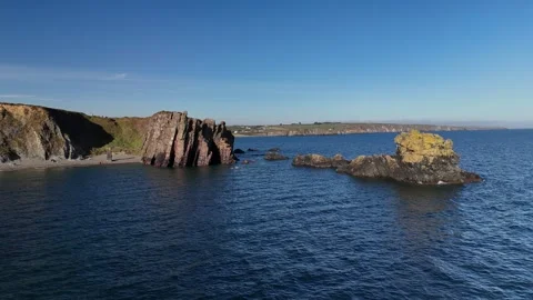 Rocky Sea Stacks and Cliffs Above Calm Ocean Water 库存影片 333414720