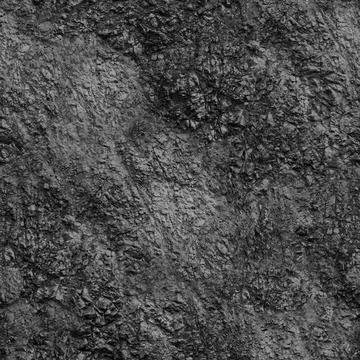 A rocky sharp wall of black stone .Texture or background The sharp edges o... Stock Photos