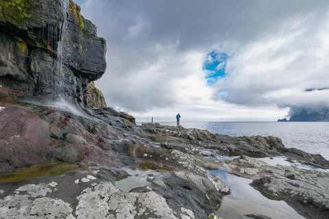 Rocky shore on a cloudy day. Cliffs of Kalsoy island. Late morning in the wild Stock Photos