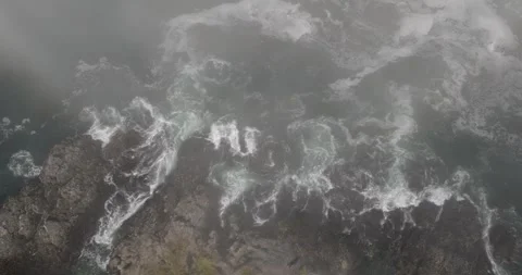 Rocky Shore with Crashing Waves Through Fog Stock Footage 290058152