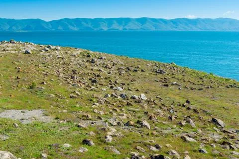 The rocky shore of Lake Sevan, a natural landmark of Armenia on a sunny day Stock Photos