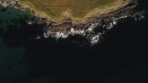 Rocky shore ocean waves breaking on stones aerial survey Stock Footage 128578926