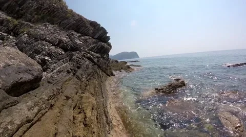 Rocky shore, silent wave beating on the shore, the rocks Stock Footage 68729904