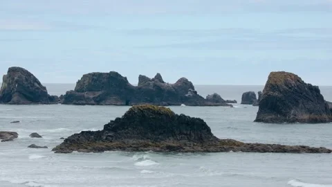 Rocky shoreline and iconic Haystack Rock at Cannon Beach, Oregon  a world-renown Stock Footage 309291960
