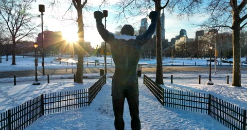 Rocky statue in Philly. Rear view into sunrise. Winter snow. Famous Movie Stock Footage 170009579