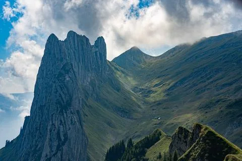 Rocky steep cliff edge with clouds in background Stock Photos