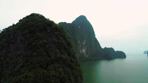 Rocky with steep slopes, small stone islands densely overgrown with trees in a Video stock 229546648