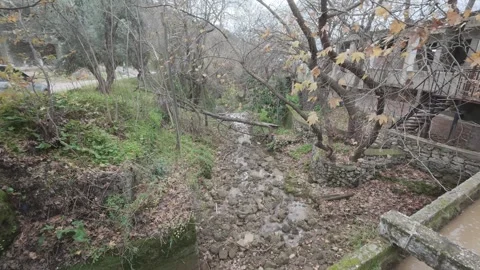 Rocky stream bed with flowing water in abandoned mountain village Stock Footage 338107408