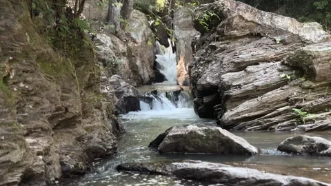 Rocky stream cascade flowing through narrow gorge near Mok Fa Waterfall Video stock 330985317