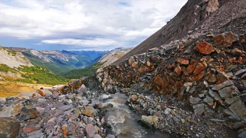 Rocky stream flowing through Glacier Basin Trail with Mount Rainier National Par Stock Footage 332144826