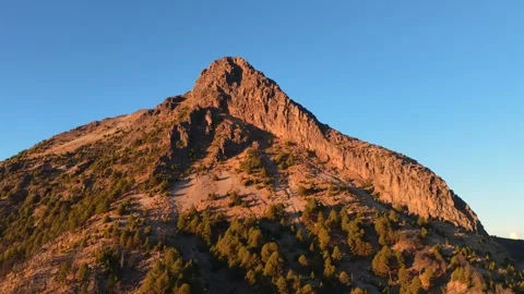 Rocky summit of Nevado de Colima (Zapotépetl) illuminated by warm golden hour Stock Footage 334137066