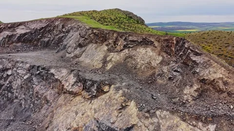 Rocky surface of a quarry shows mining activity in a remote area Stock Footage 338275840