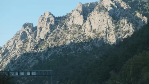 Rocky Taurus range in Turkey seen from a car with speed limit signs Stock Footage 146029864