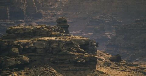 Rocky terrain with jagged cliffs and distant formations in natural landscape Stock Illustration