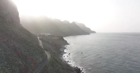Rocky volcanic beach surrounded by high mountains and cliffs aerial drone view Stock Footage 171260264
