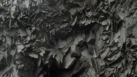 Rocky wall with unique hexagonal pattern in a wet cave in Iceland Stock Footage 253841134