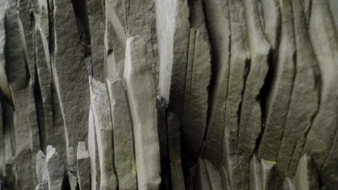 Rocky wall with unique hexagonal pattern in a wet cave in Iceland Stock Footage 253841152